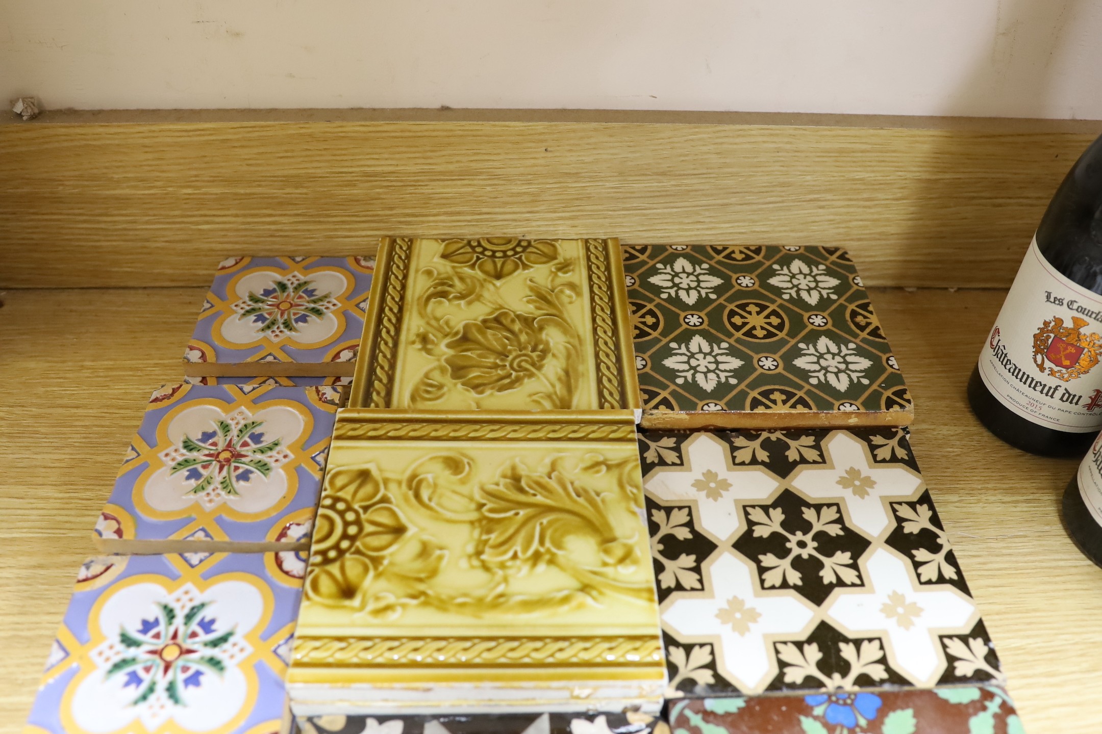 A selection of 19th and 20th century tiles, including Minton encaustic and W. Godwin tiles